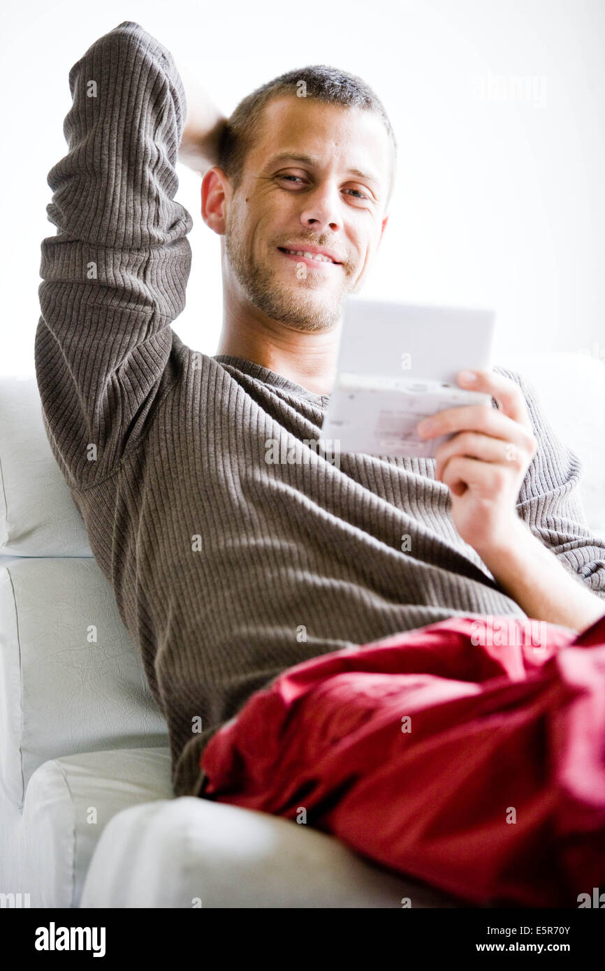 Man playing with a video game console. Stock Photo