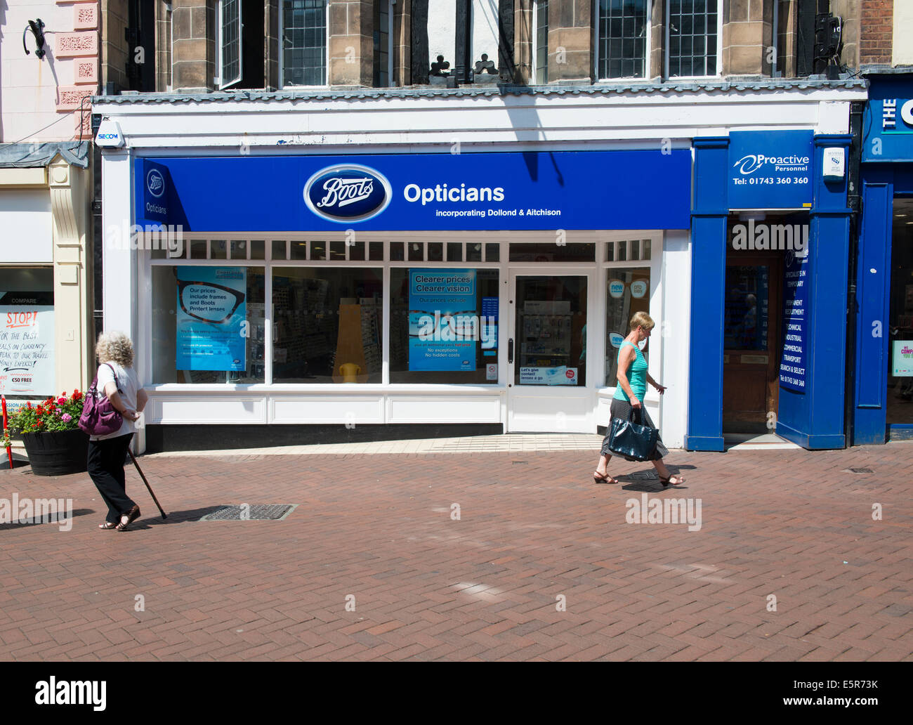 People walking past a Boots Opticians store in Shrewsbury, Shropshire, England, UK Stock Photo