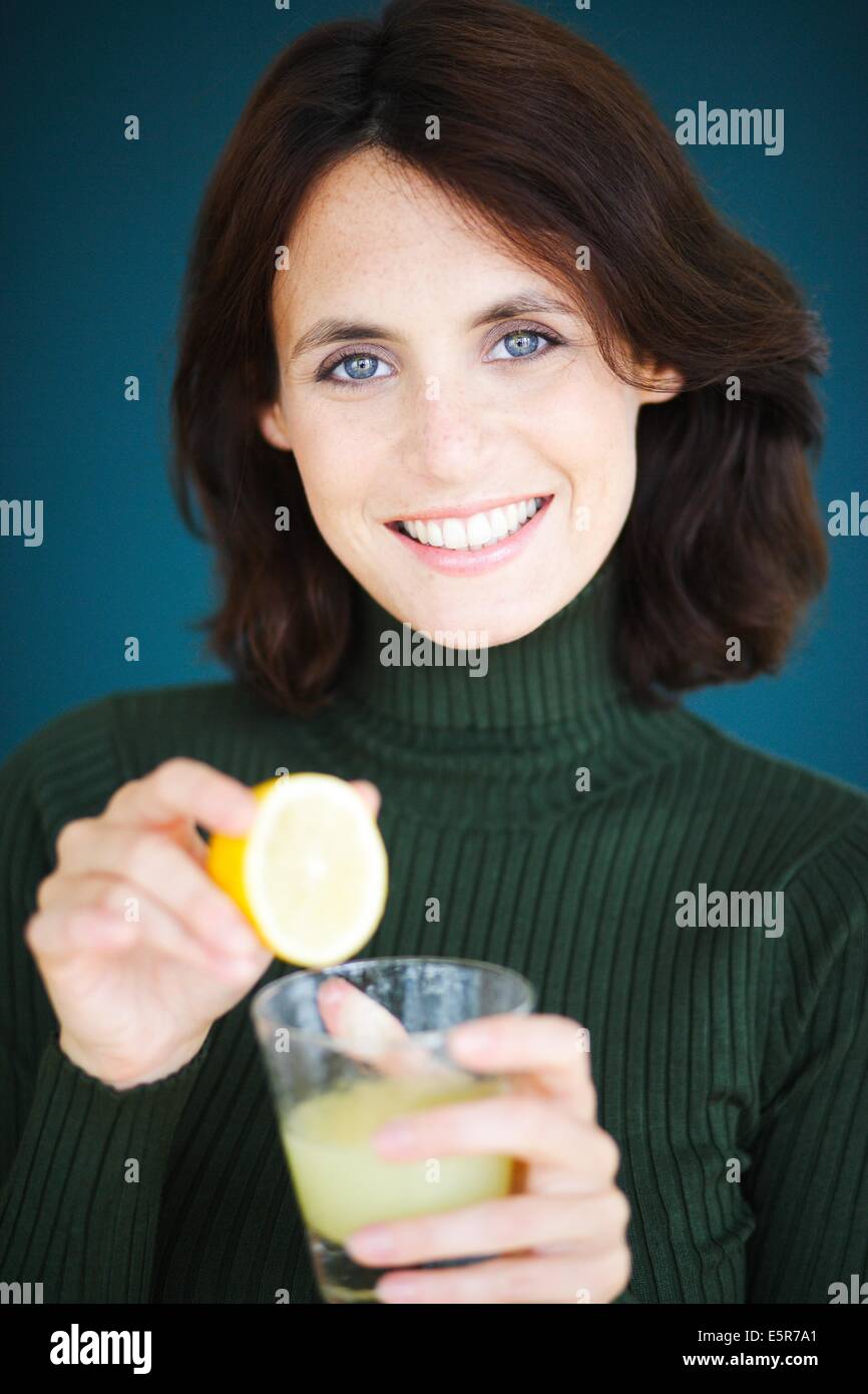 Woman drinking freshly squeezed lemon juice Stock Photo Alamy