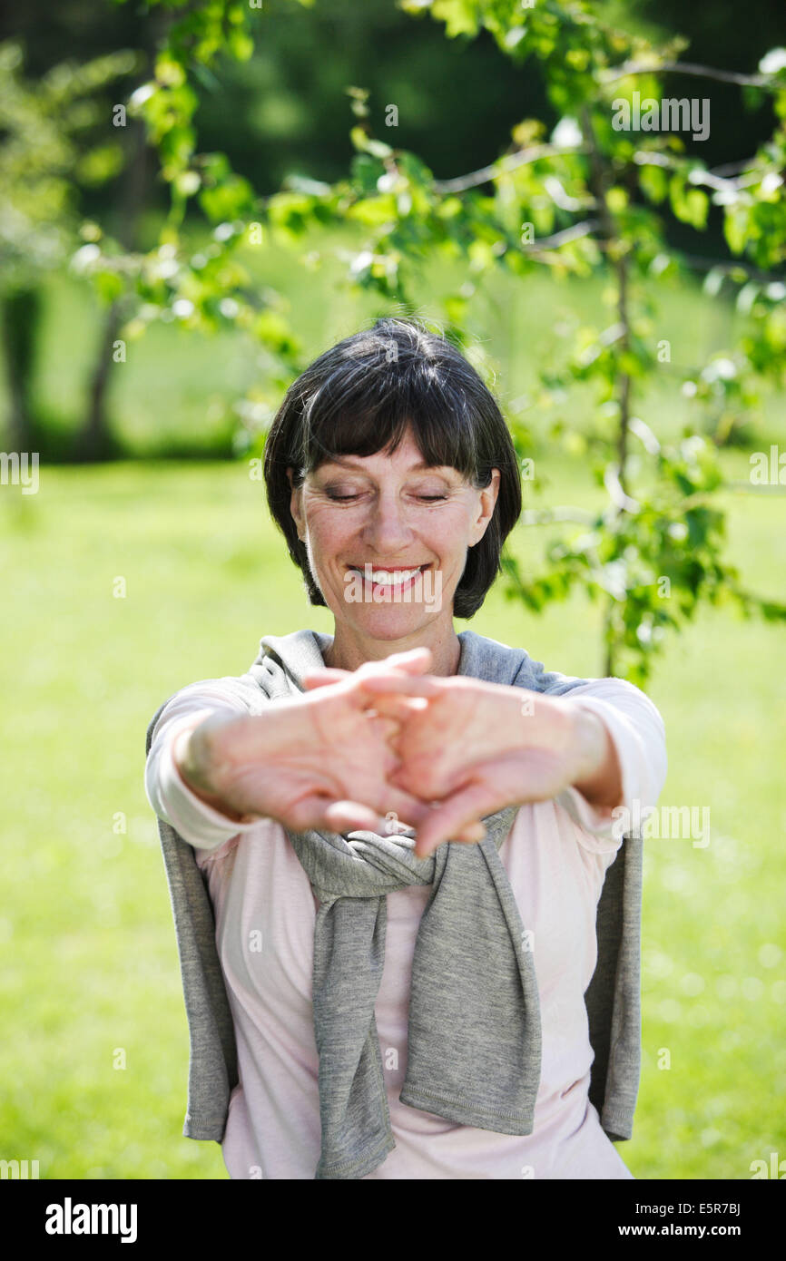 60 year old woman stretching. Stock Photo