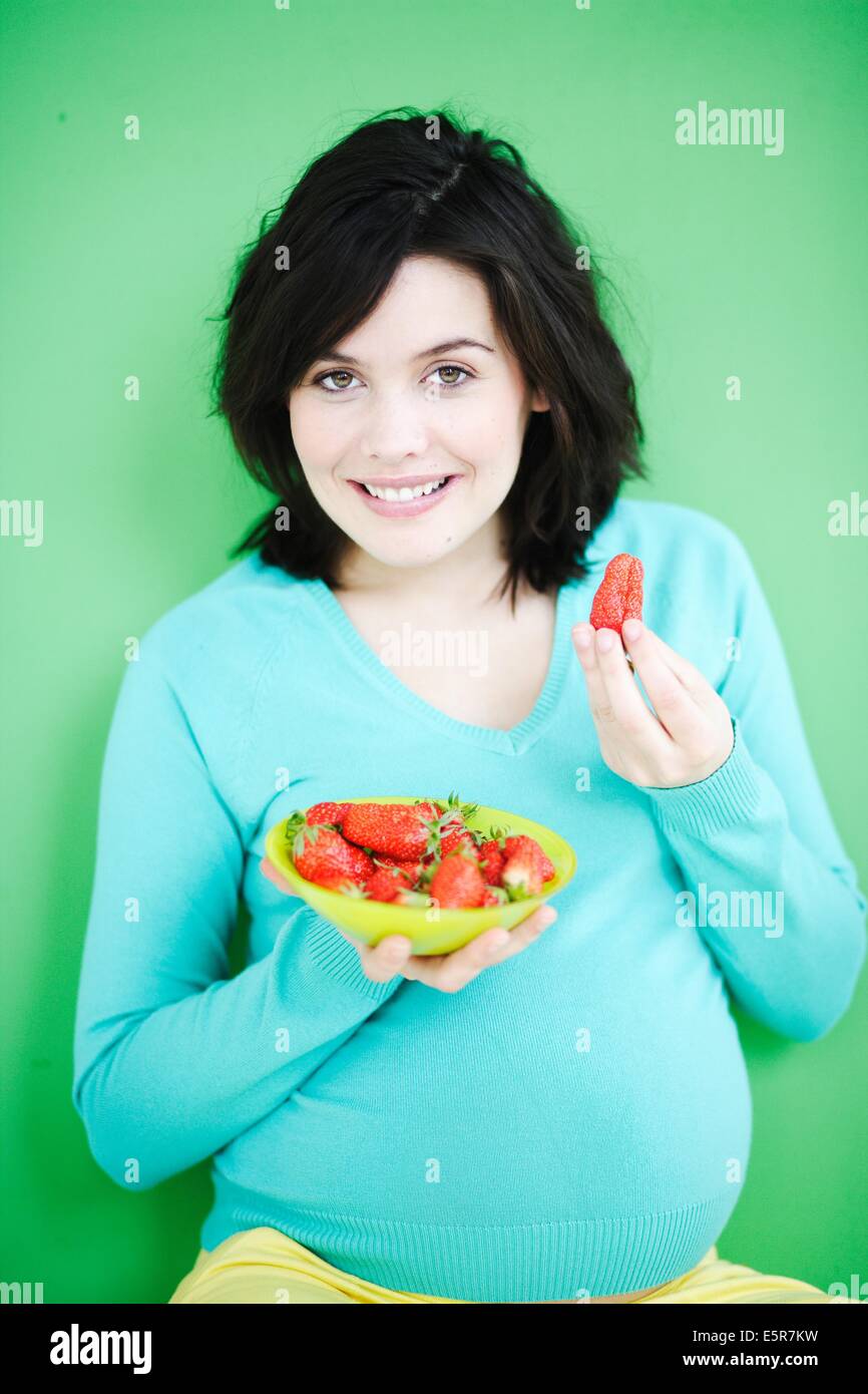 Pregnant woman eating strawberries Stock Photo Alamy