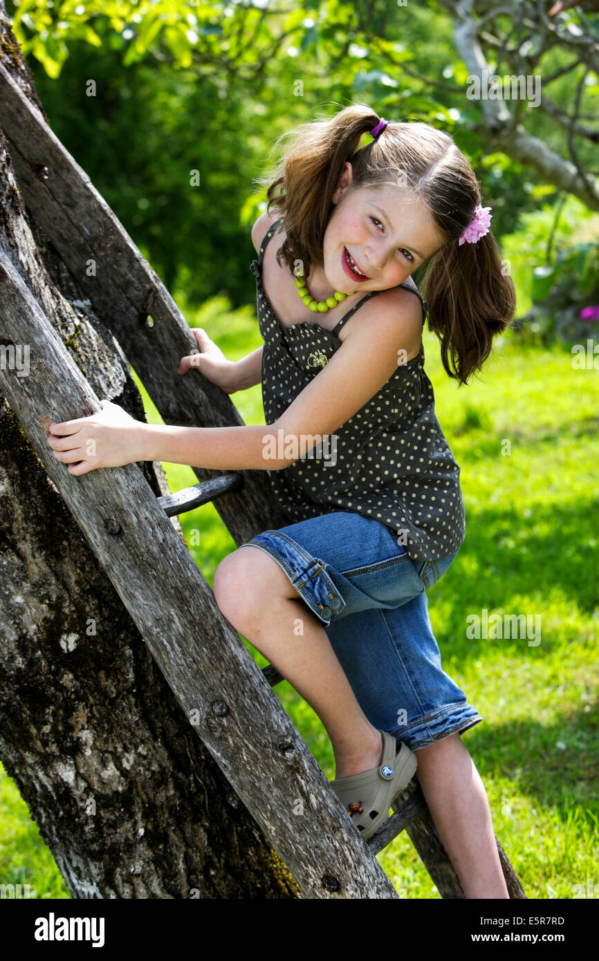 7 Year Old Girl Climbing Ladder Stock Photo Alamy
