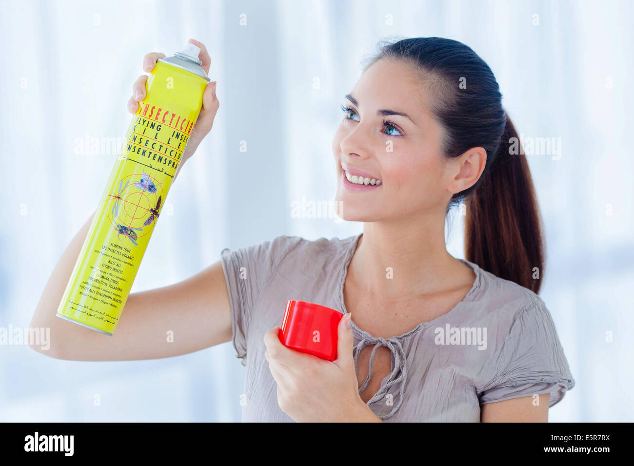 Woman using an insecticide in spray Stock Photo Alamy
