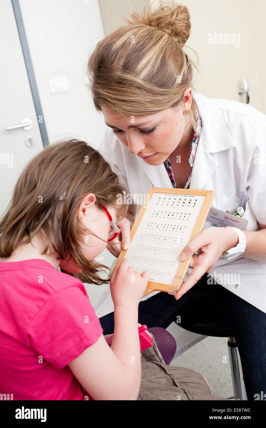Young girl undergoing orthoptic check-up with an orthoptist, Department of Pediatric Ophthalmology, Bordeaux hospital, France. Stock Photo