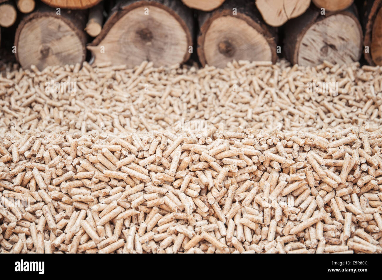 Pine pellets in front a wall of firewoods Stock Photo Alamy