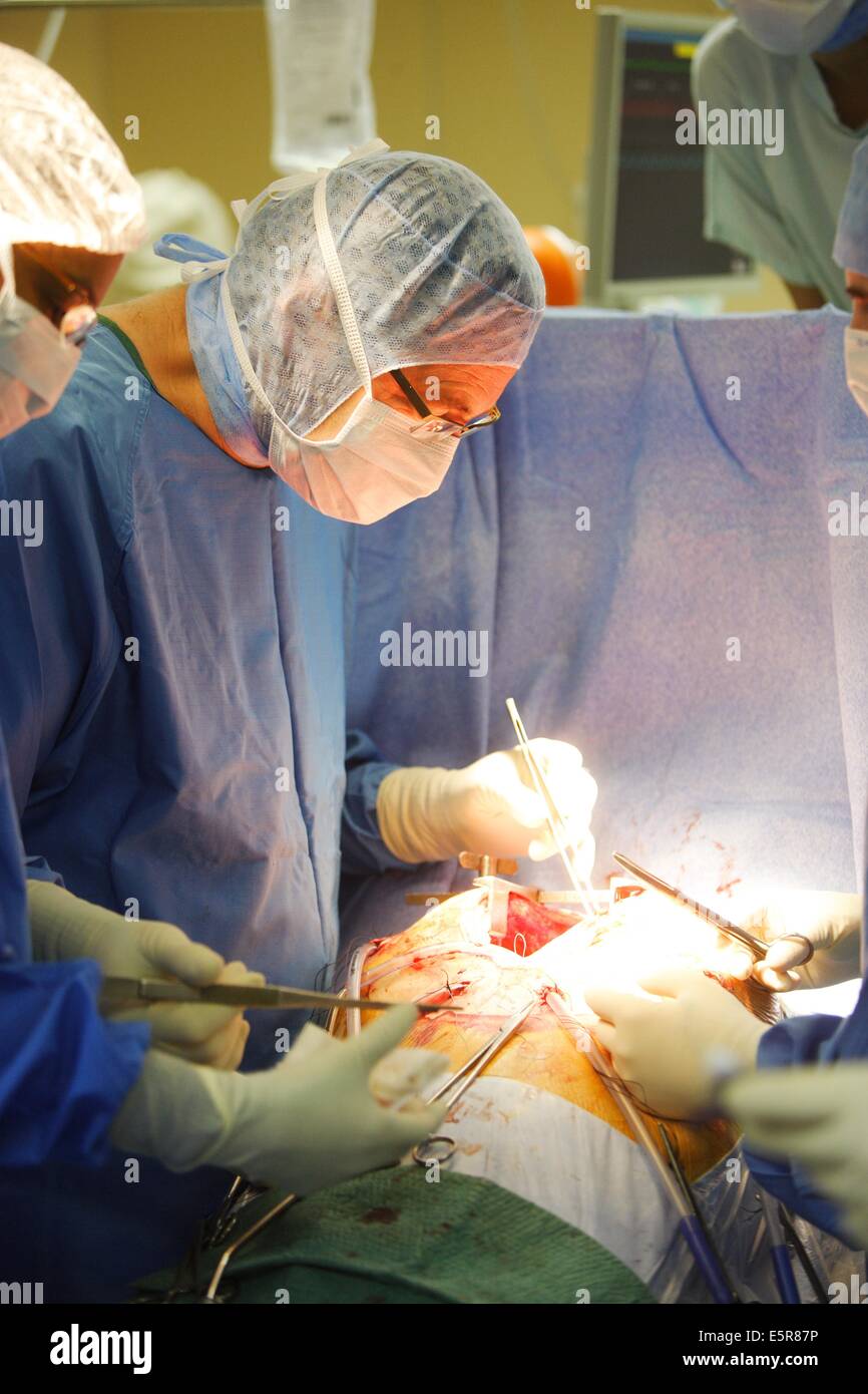 Surgeon performing mitral valve replacement surgery, an open heart