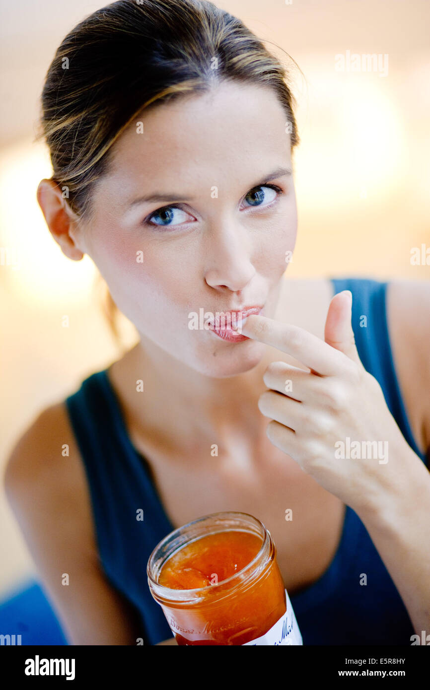 Woman eating jam Stock Photo Alamy