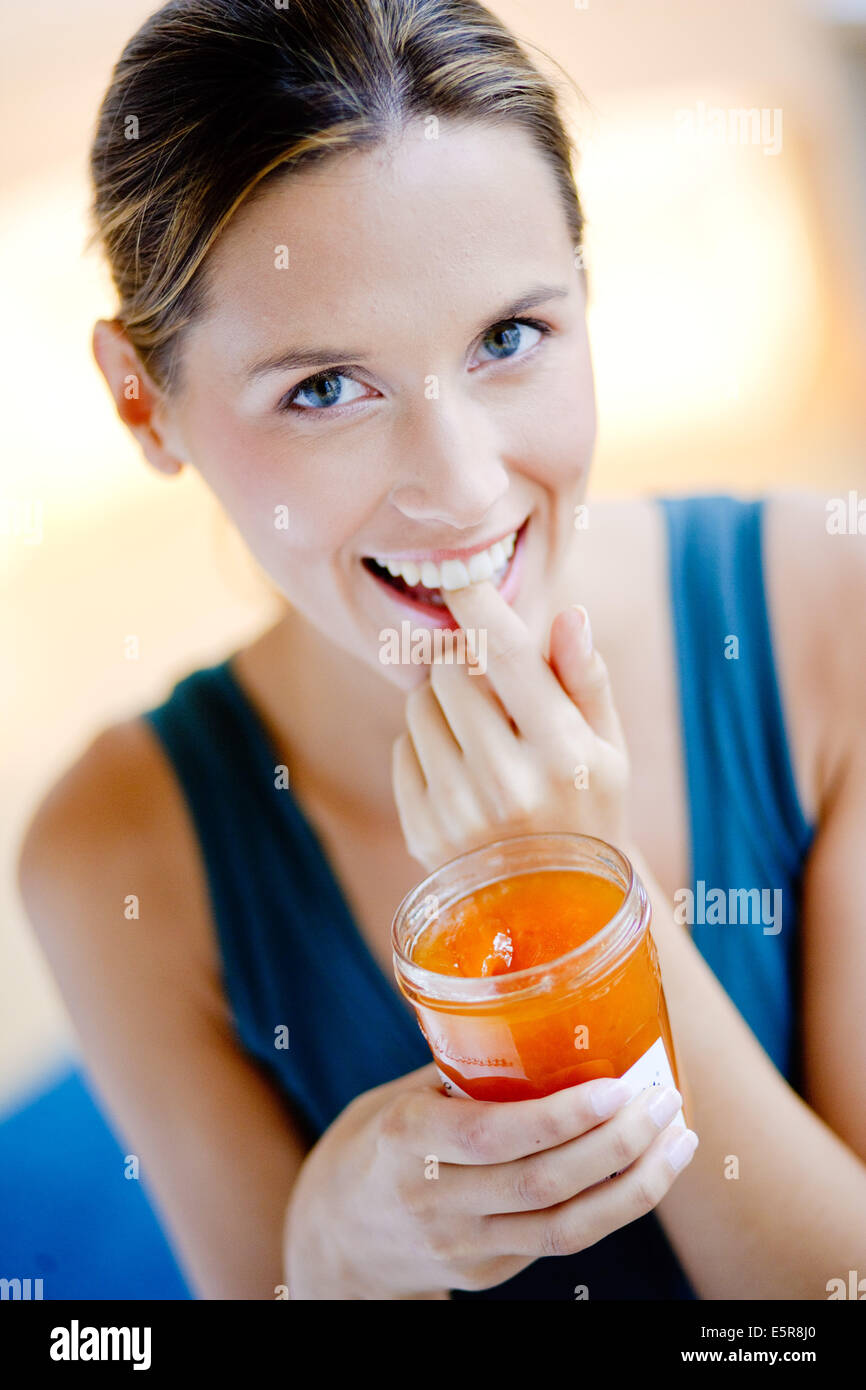 Woman eating jam Stock Photo Alamy