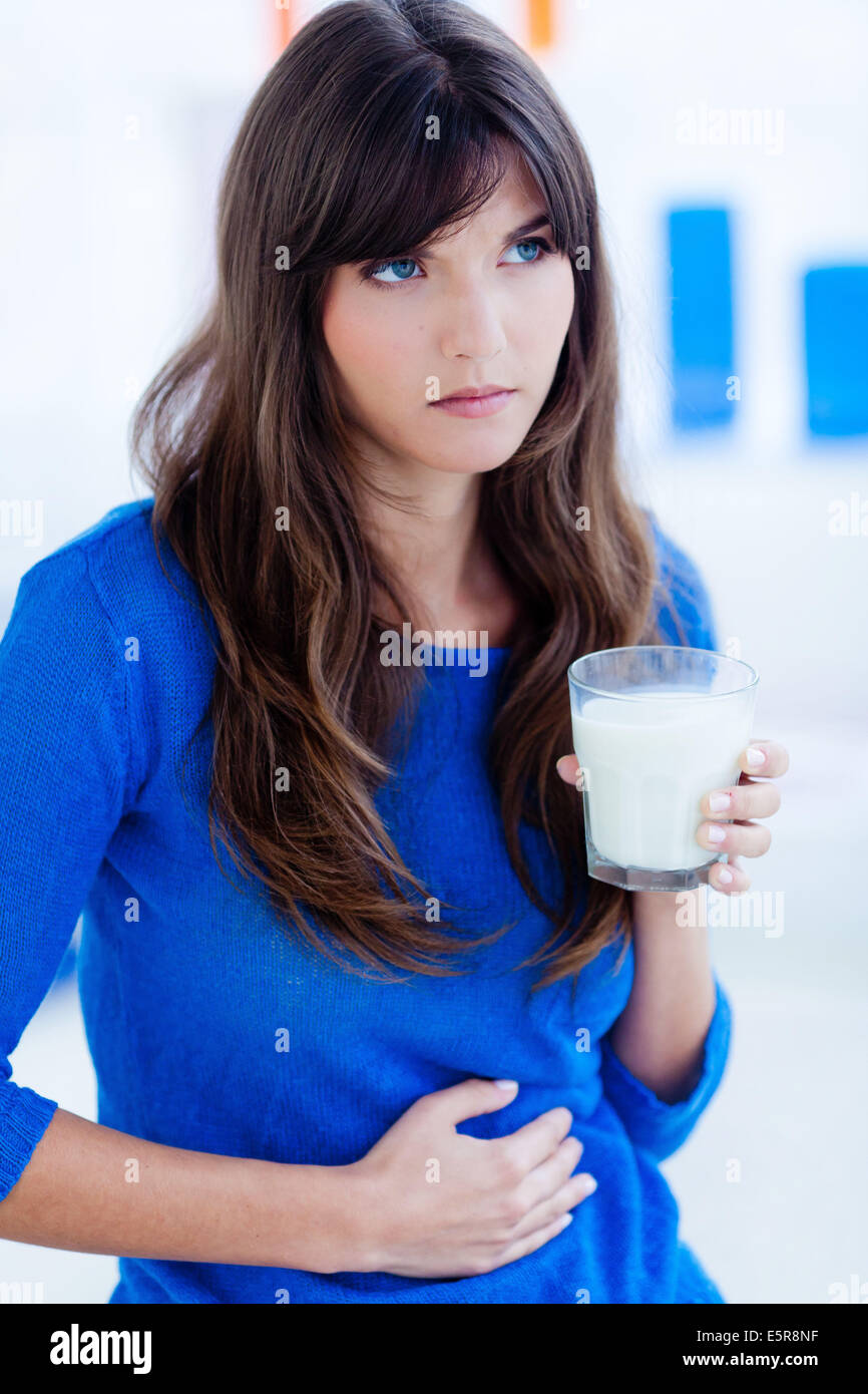 Woman drinking a glass of milk. Stock Photo