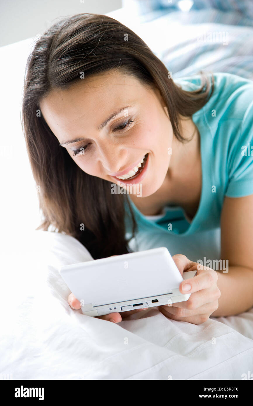 Woman playing with a video game console. Stock Photo