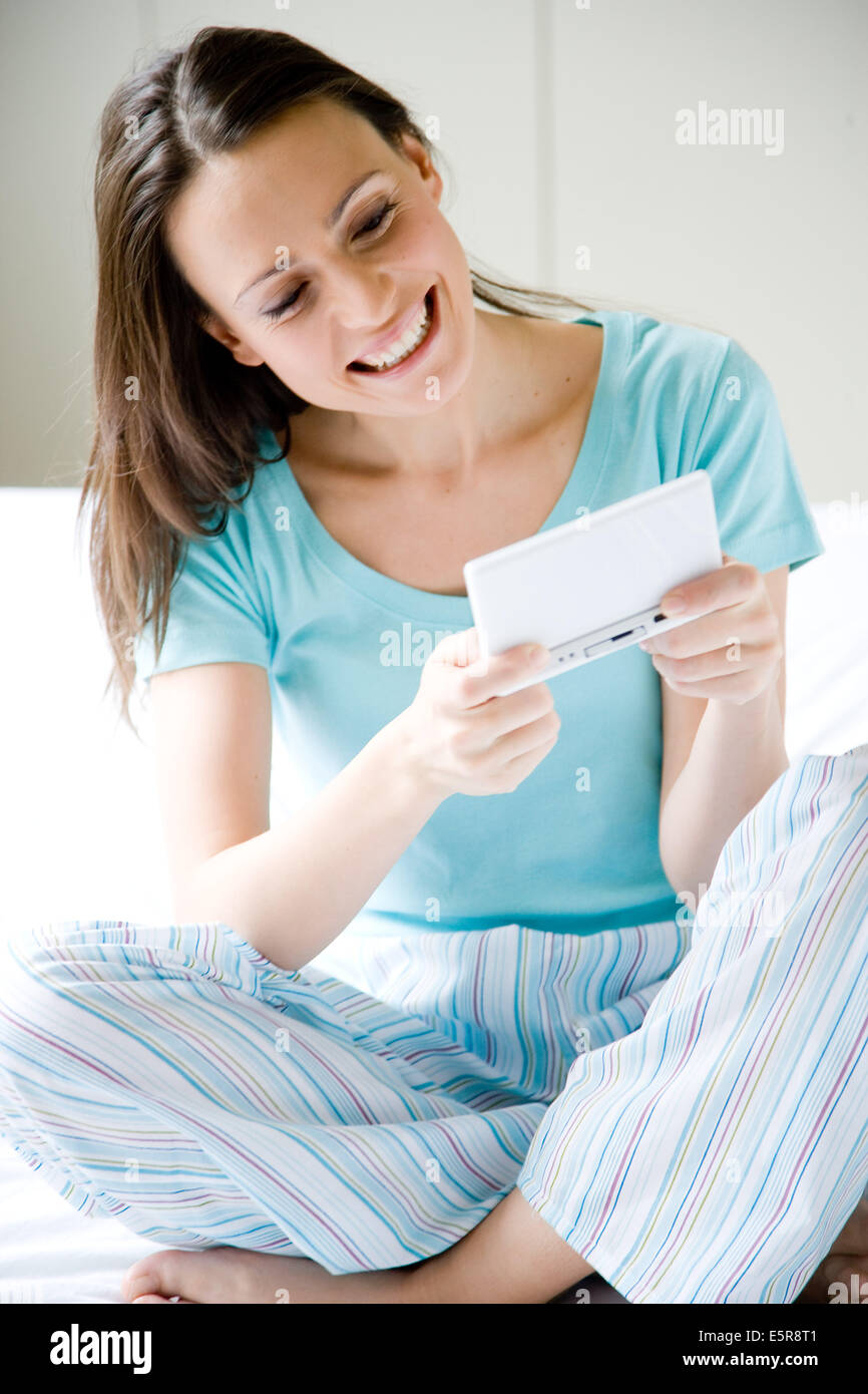 Woman playing with a video game console. Stock Photo