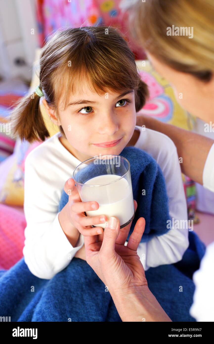 girl drinking bottle of milk laying on bed blond toddler Stock Photo - Alamy