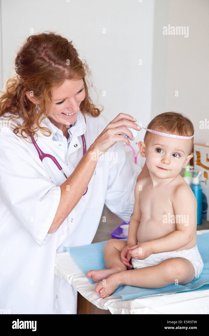 Nurse Measures Babys Head Circumference Stock Photo - Download