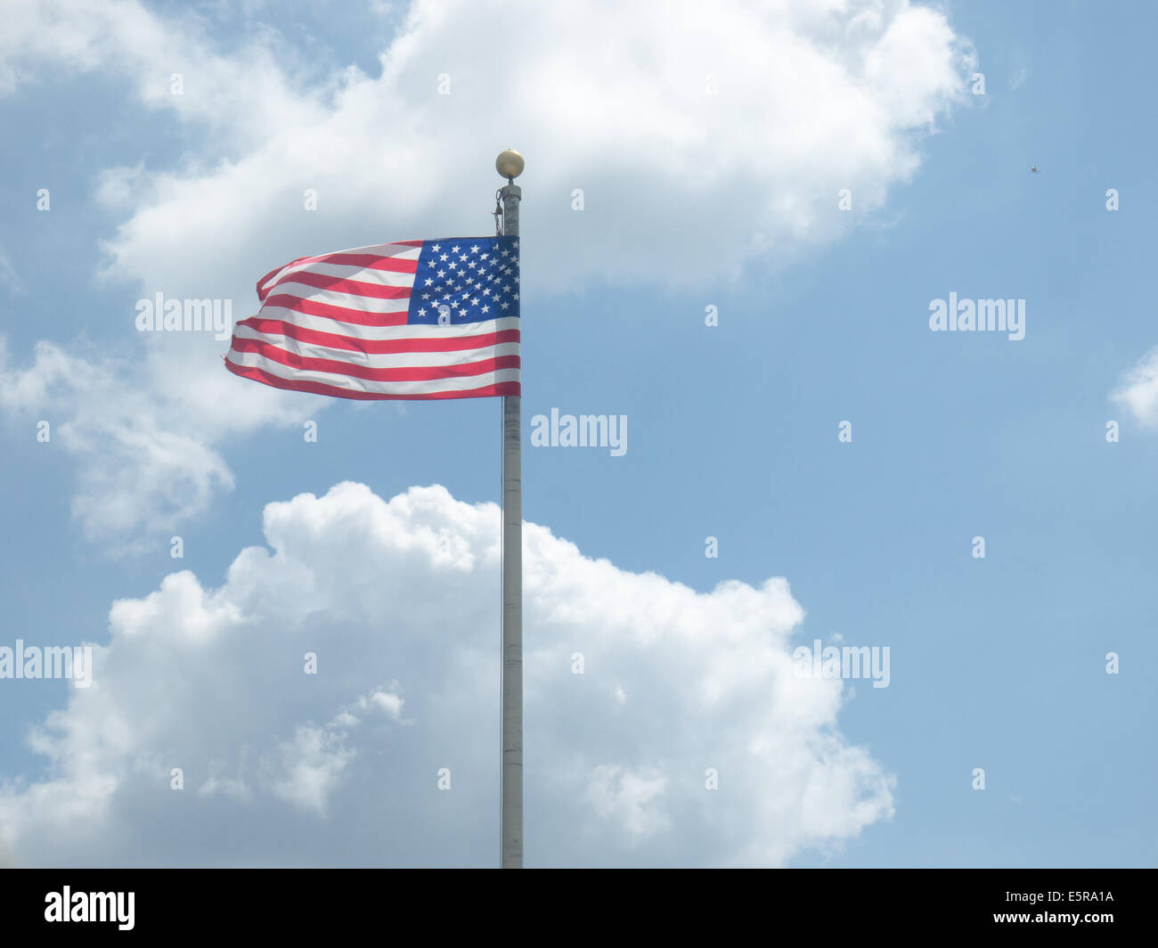 US flag against clear blue sky Stock Photo