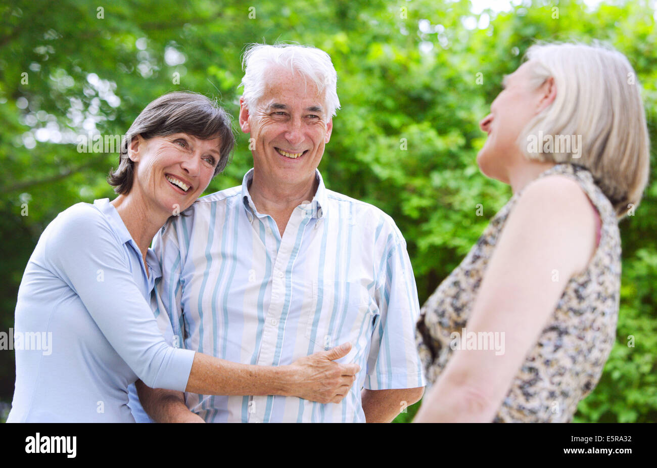 Senior couple with friend Stock Photo - Alamy