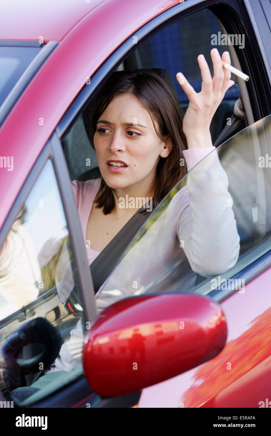Woman smoking cigarette when driving Stock Photo - Alamy