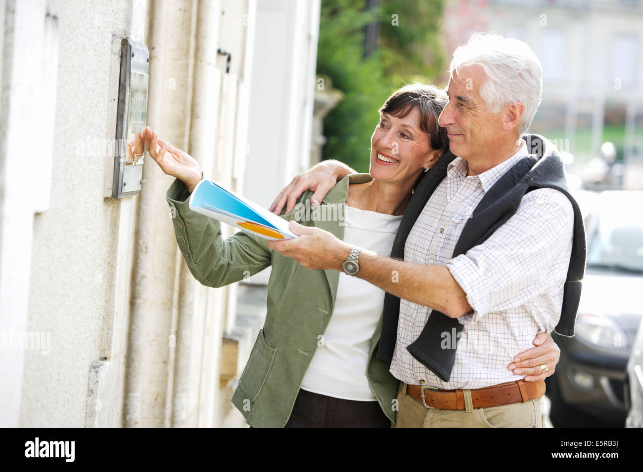 60 year old couple looking at professional brass plaque. Stock Photo