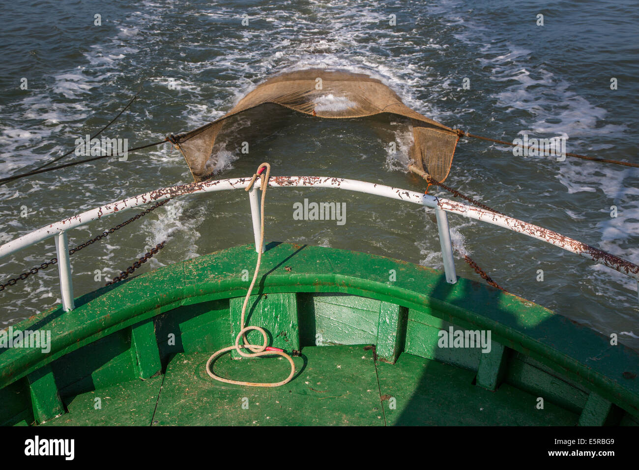 Shrimp boat with fish net fishing for shrimps on the North Sea Stock Photo