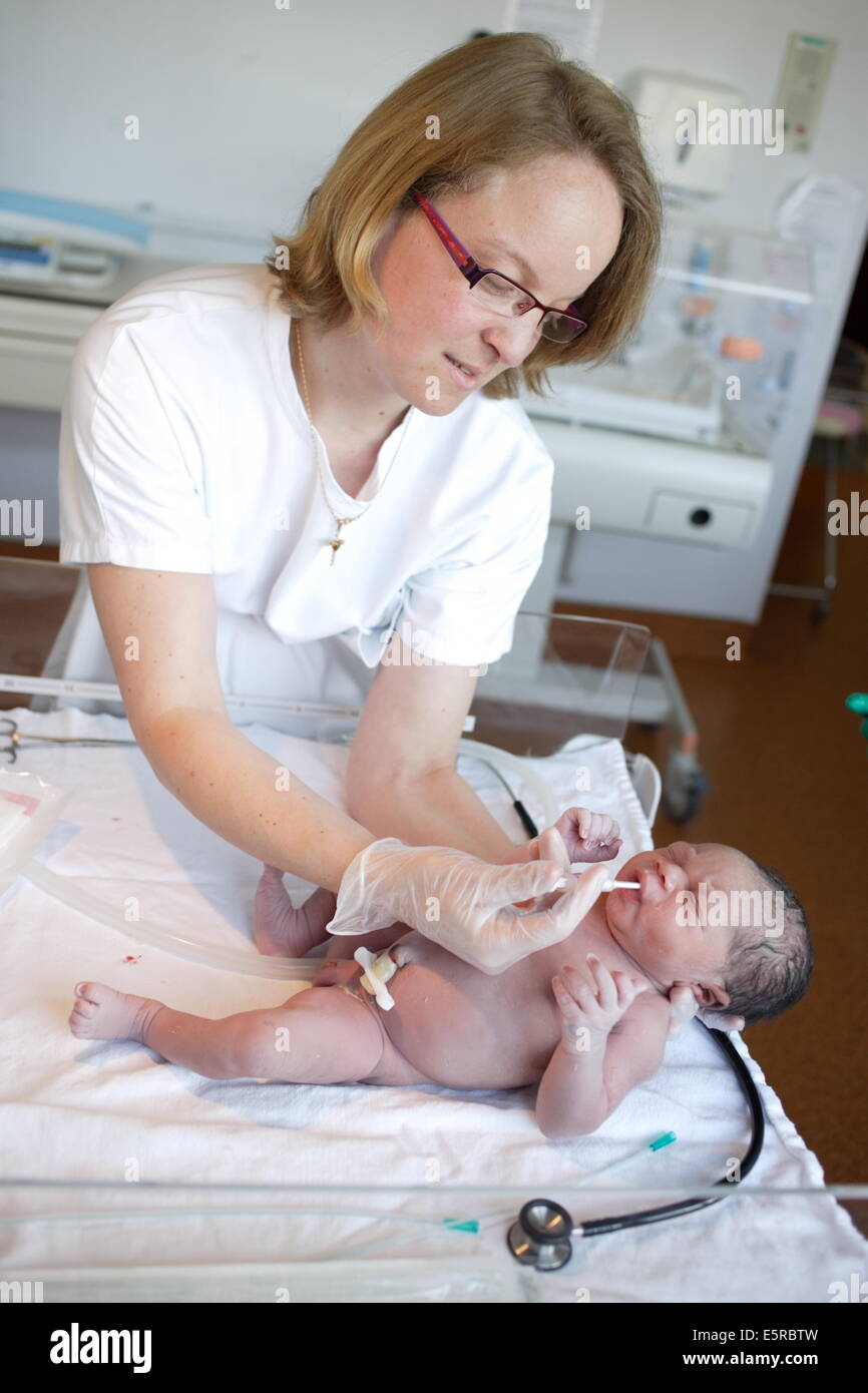 Midwife giving a newborn baby vitamin K, Obstetrics and gynaecology