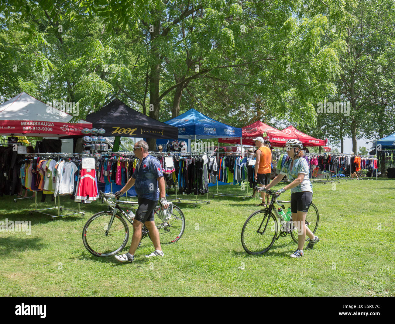 Recreational cyclist passing by a summer outdoor market Stock Photo