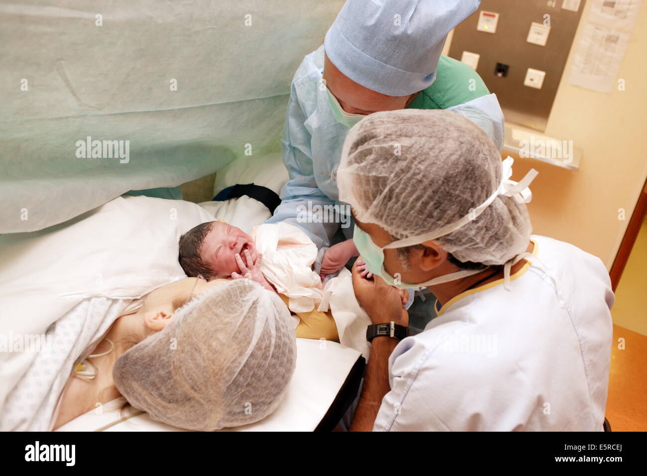 Mother with newborn baby after ceasarean delivery, Obstetrics and gynaecology department, Saintonge hospital, Saintes, France. Stock Photo