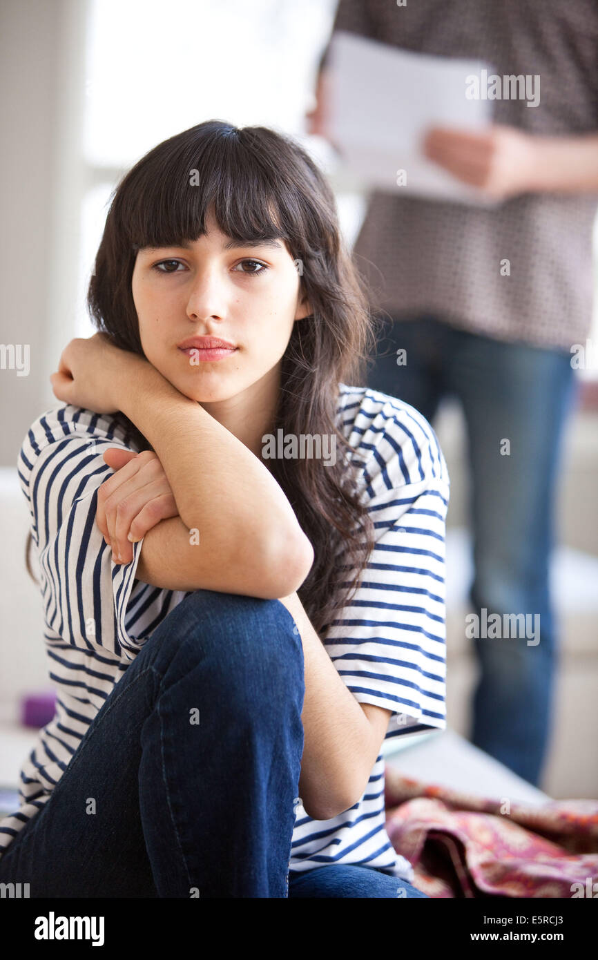 Teenage girl with adult man in background Stock Photo - Alamy