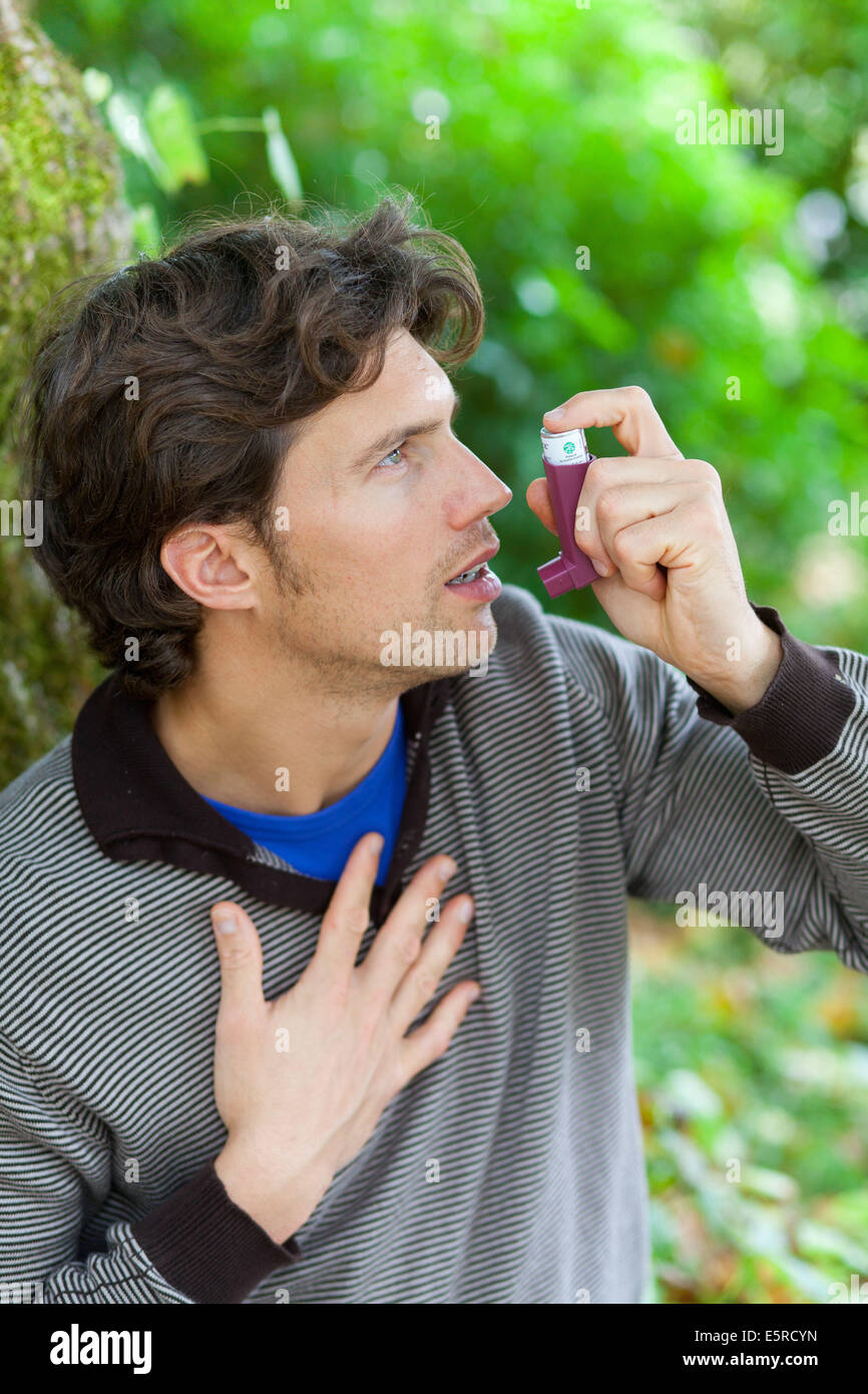 Man using an inhaler during an asthma attack Stock Photo Alamy