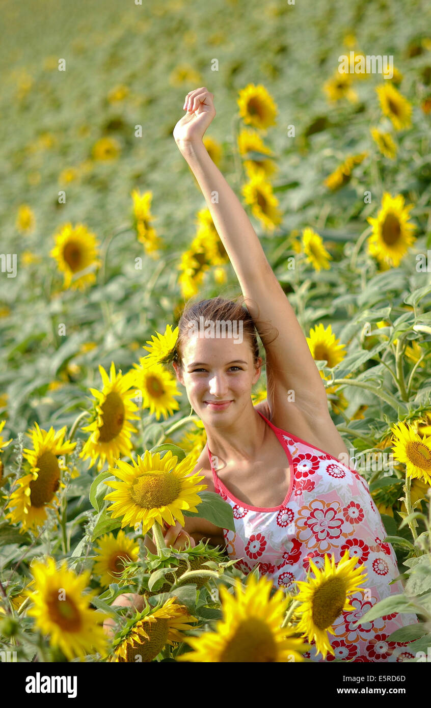 Woman in a sunflower field Stock Photo - Alamy