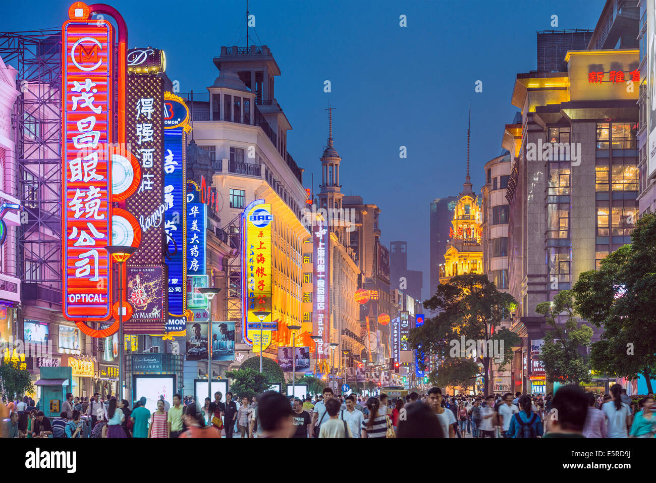 Neon signs lit on Nanjing Road in Shanghai. The street is the main shopping road of the city. Stock Photo