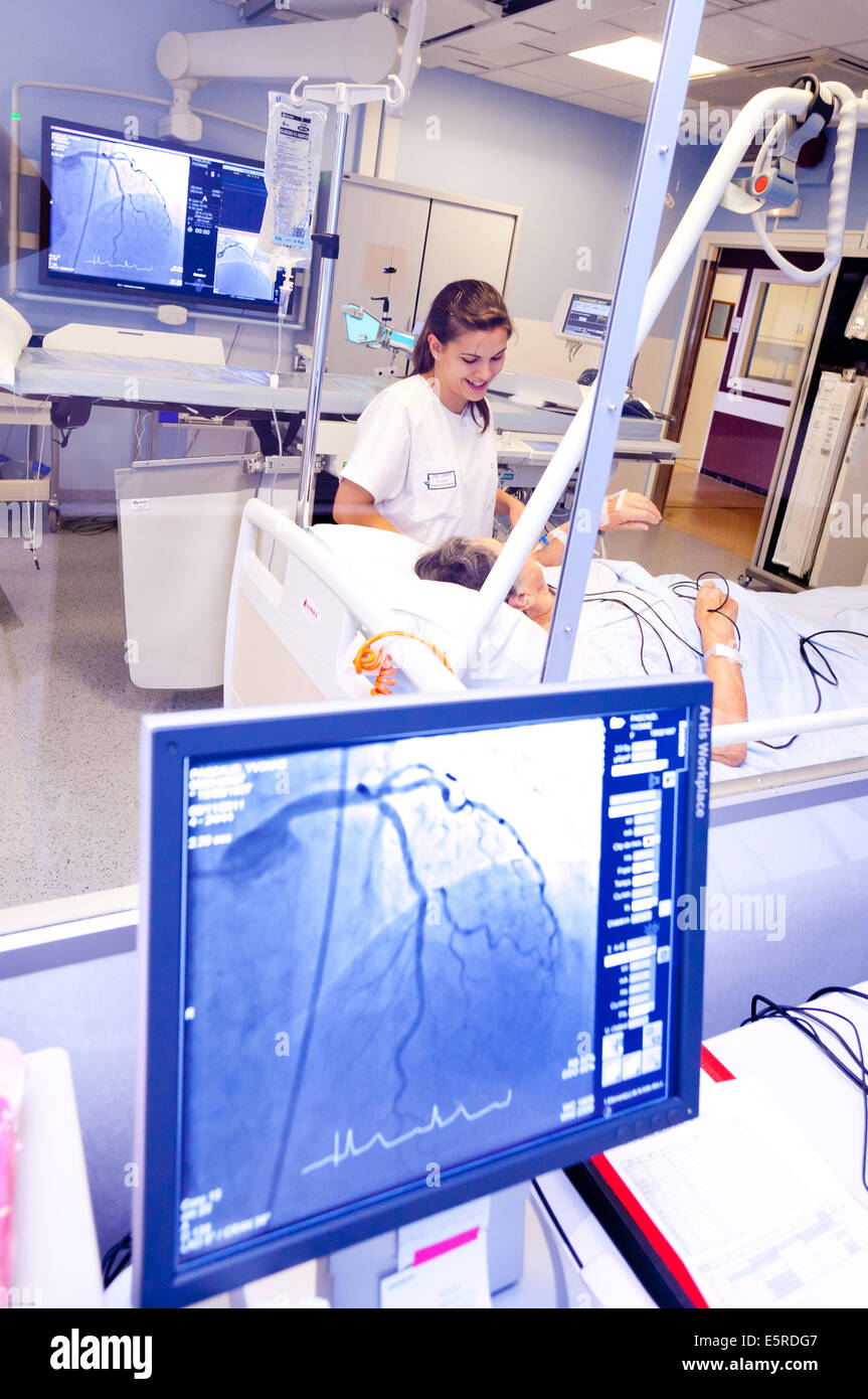Hemodynamic diagnostic angiography and interventional cardiology, Nurse talking to a female patient at the end of the Stock Photo