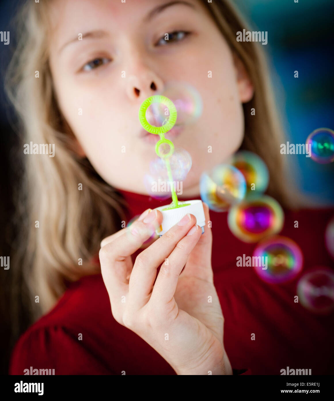 Woman making soap bubbles. Stock Photo