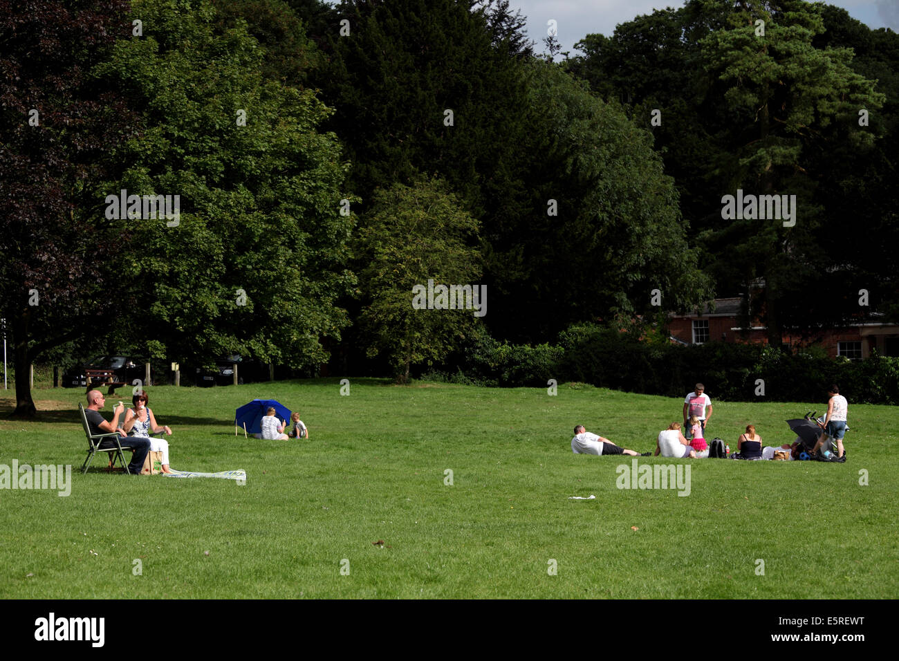 Coltishall, Norfolk, UK. 4th August 2014. People were out in force today all over the Norfolk broads enjoying the summer sun.Here poeple are having picnics by the river. Credit:  Paul Lilley/Digitalshot/Alamy Live News Stock Photo