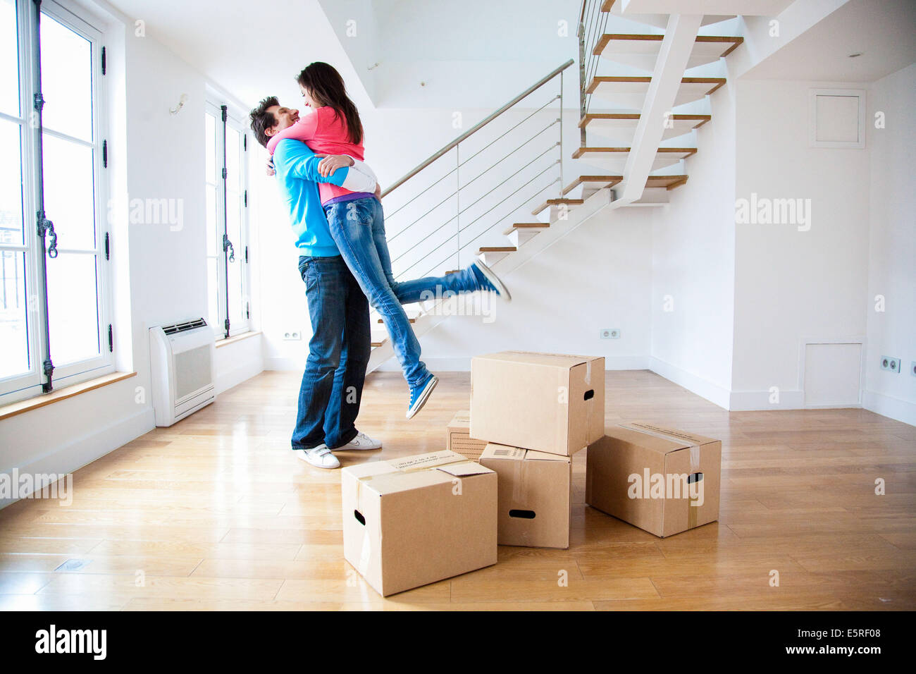 Couple moving into new home Stock Photo - Alamy
