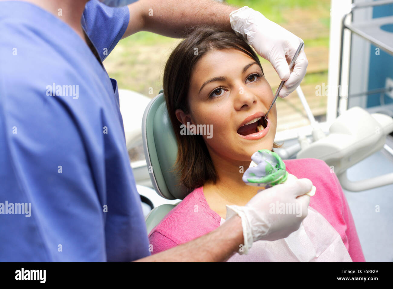Dentist making an impression before making artificial crown. Stock Photo