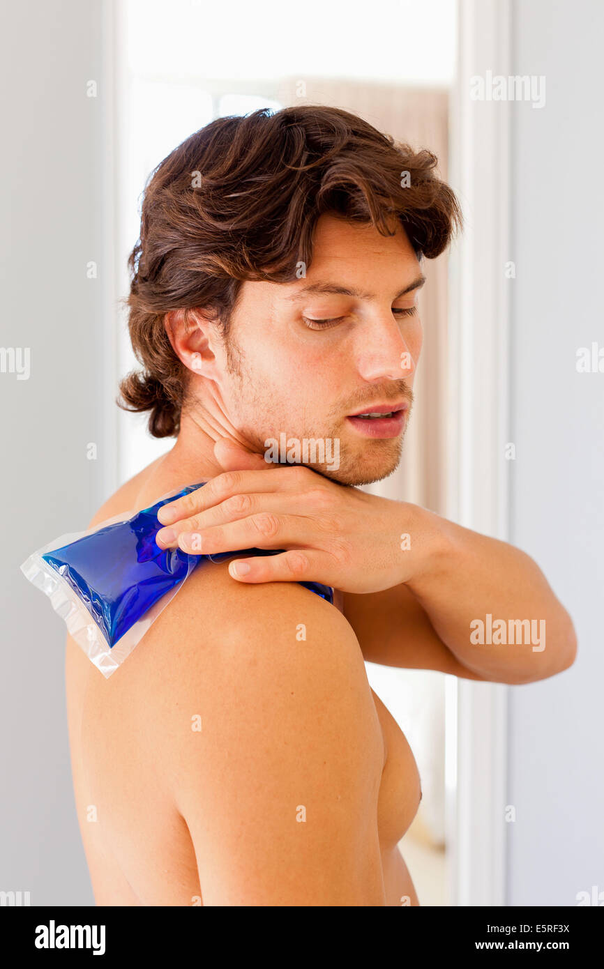Man using a hotcold gel pack treatment to releive pain Stock Photo Alamy