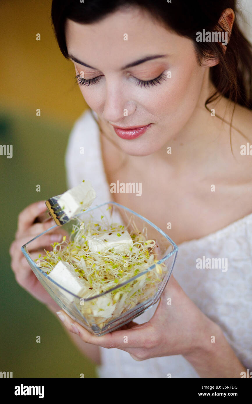 Woman eating tofu Stock Photo - Alamy