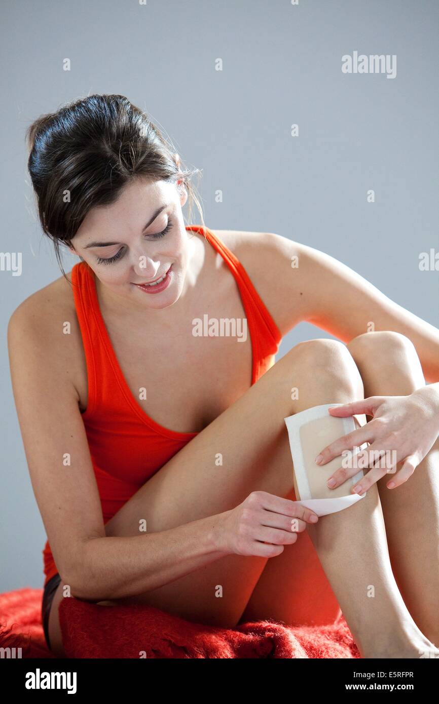 Woman wax epilation her legs. Stock Photo