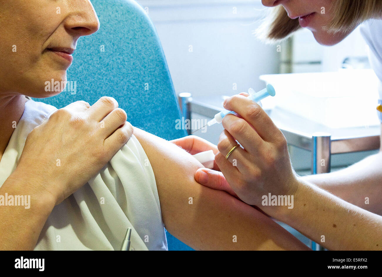 Woman receiving H1N1 influenza (flu) vaccine.. Stock Photo