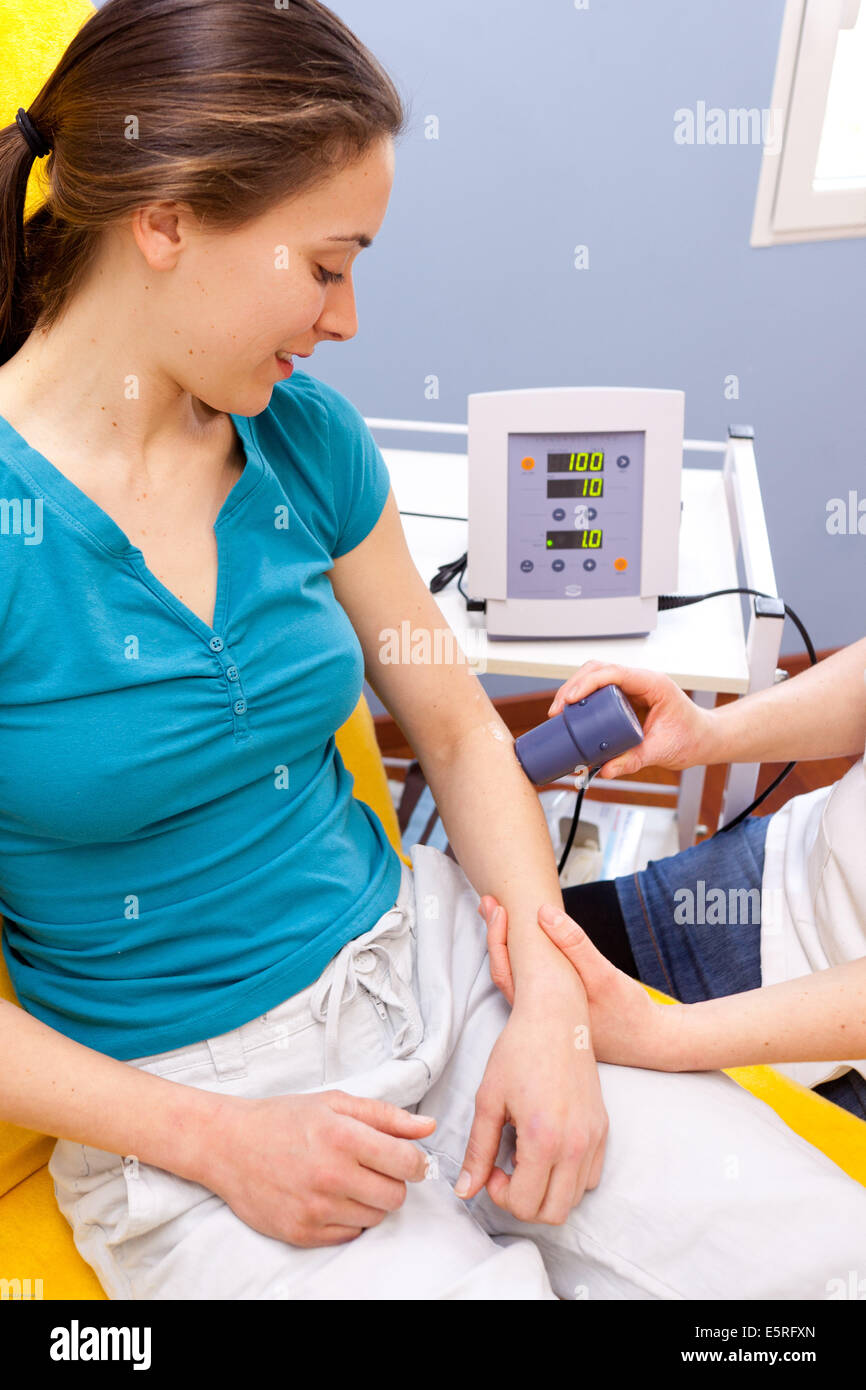 Ultrasound physiotherapy : treatment of tennis elbow with ultrasounds. Stock Photo