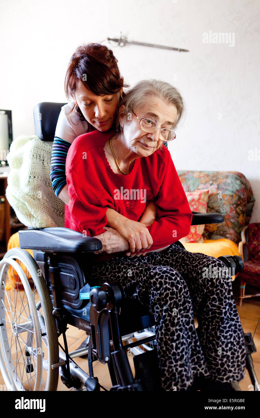 Physiotherapy session at the home of an elderly woman with a disability. Stock Photo
