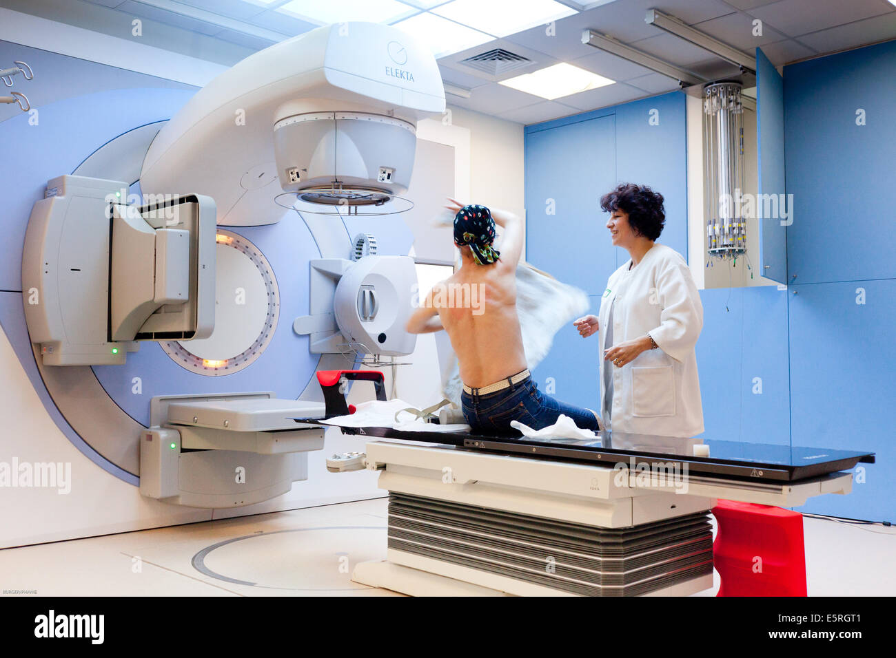 Radiotherapy radiographer talking to a female patient treated with
