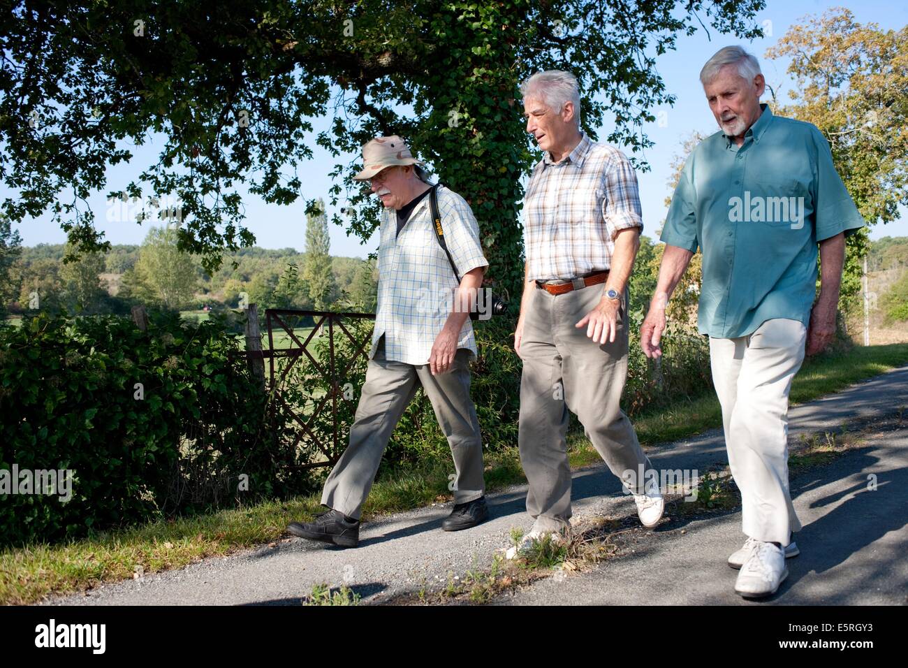 Seniors walking on countryside of Perigord, France. Stock Photo
