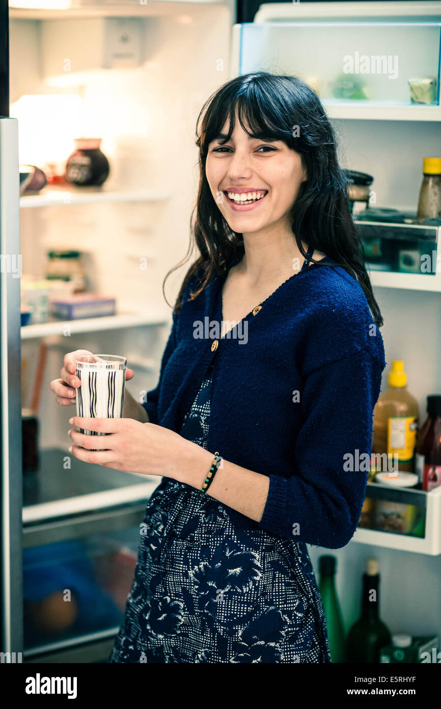 Young woman holding a glass of milk. Stock Photo