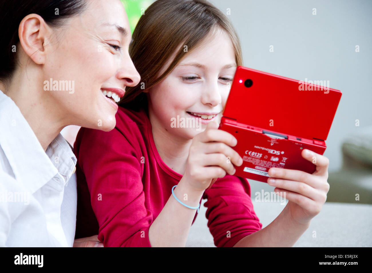 9 year old girl playing with video game console. Stock Photo