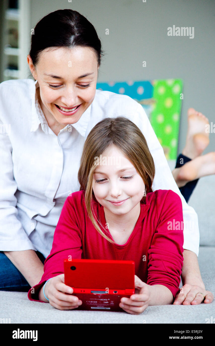 9 year old girl playing with video game console. Stock Photo