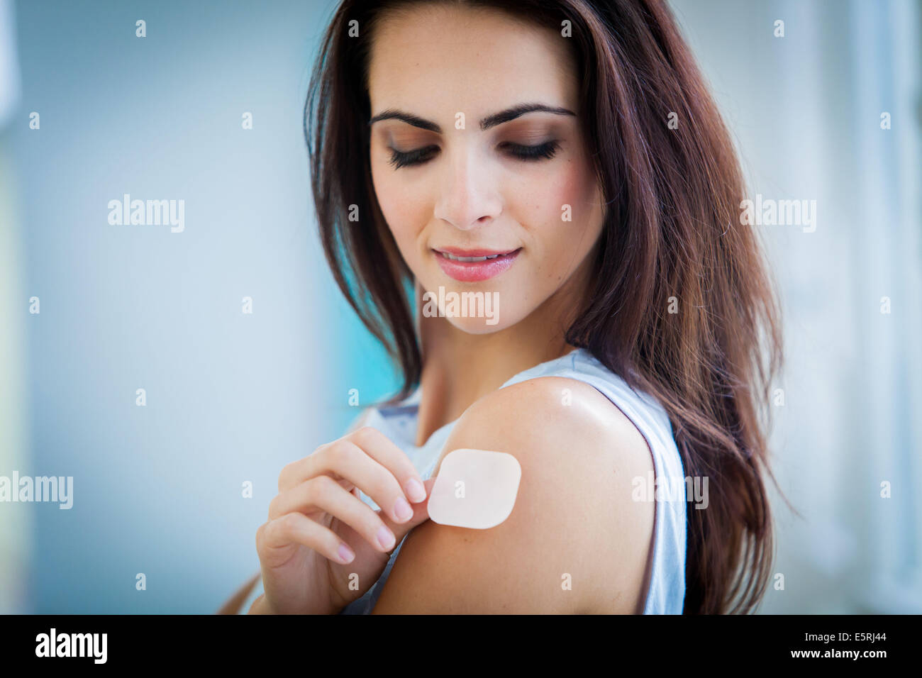 Woman applying a nicotine patch hires stock photography and images Alamy