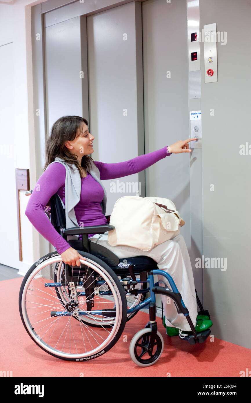 Disabled people using a lift adapted to disability. Stock Photo