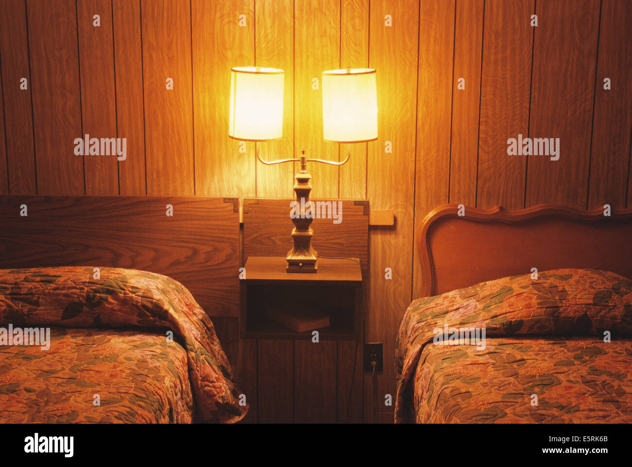 Motel room interior with two beds and nightstand Stock Photo