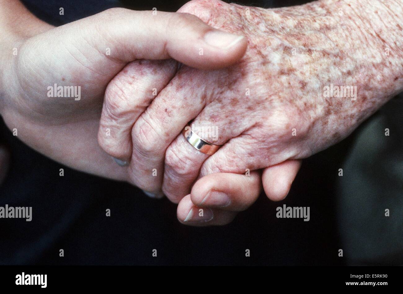 Geriatric care, close up of young and elderly women's hands. Stock Photo