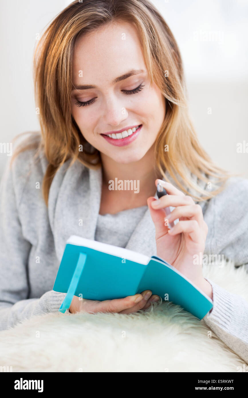 Woman writing in a notebook. Stock Photo